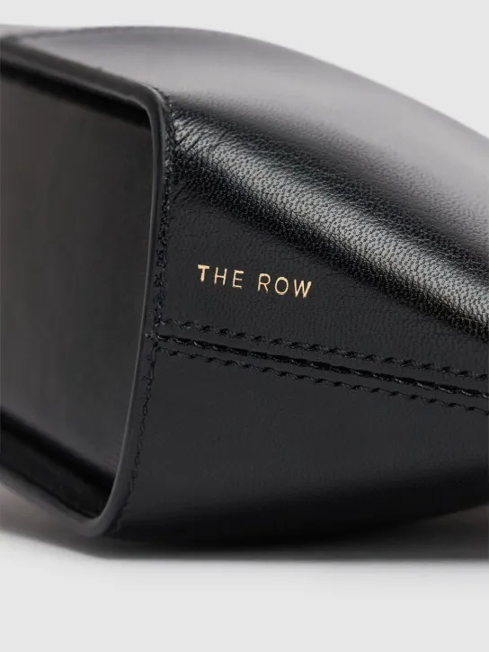 The Row   Mel shiny leather clutch 